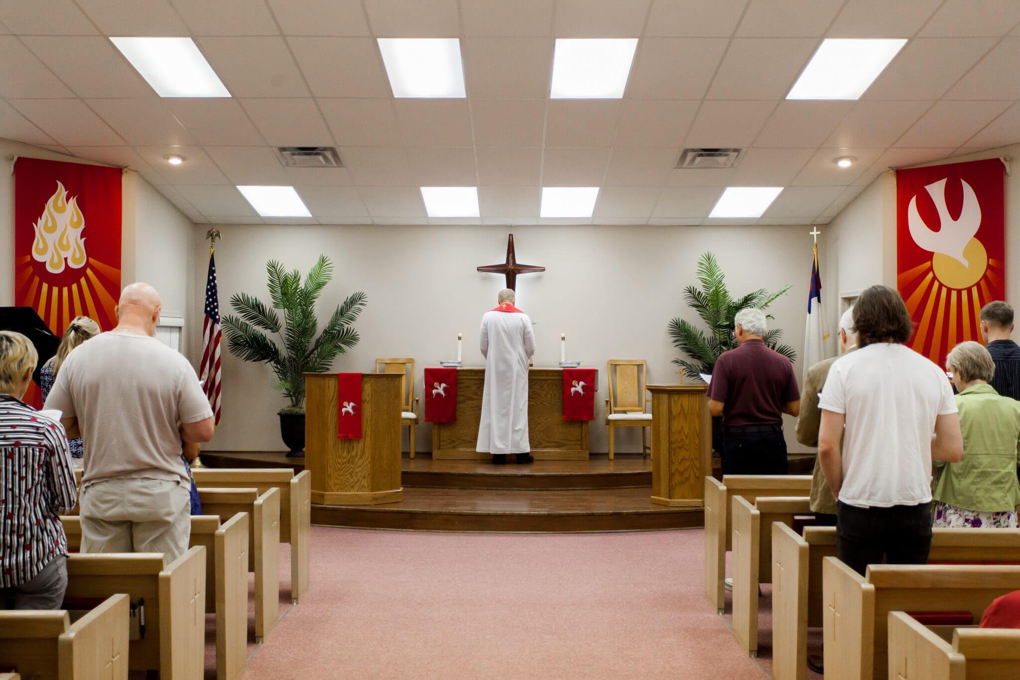 Pastor leading prayer at Risen Savior Lutheran Church